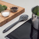 Cooking ingredients and utensils on a kitchen counter with an induction stove.