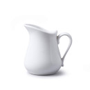 A white porcelain milk jug against a plain white background.