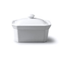 A white porcelain butter dish with lid on a white background.