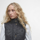 A close up of a woman wearing a buttoned up gilet