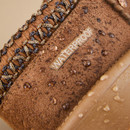 Close-up of a waterproof boot with droplets on the surface.