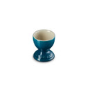 A teal egg cup with Le Creuset branding