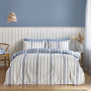A view of a reversible white bedding set with blue stripes