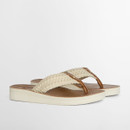 A pair of sandals with white crochet straps and white edging on the soles.