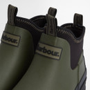 A close up view of the black Barbour logos and pull tabs at the front of the wellingtons.