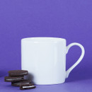 White mug on a purple background with a stack of cookies beside it.