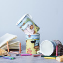 Three stacked cups with animal designs, surrounded by snacks, crayons, and an open book.