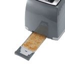 A close up view of the toasters removable crumb tray.