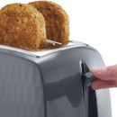 A close up view of the toaster's leaver being lifted to allow two slices of toast to be removed.