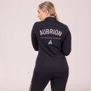A person from behind wearing a black sporty outfit with the "Aubrion" brand logo.