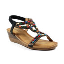 Colourful beaded wedge sandal on a white background.