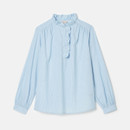 Light blue blouse with ruffled neck and button-up detail on white background.