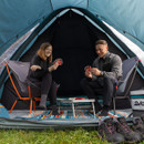 A grey camping chair with an orange lightweight metal frame and black hinges. The fabric is slightly reclined, suggesting a relaxing outdoor use.