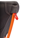 Close-up of a chair corner showing a gray fabric backrest with red stitching, supported by an orange metal frame, and a small red loop attached.