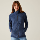 A woman wearing a navy full zip fleece with a high collar.