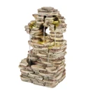 Stacked stone tabletop fountain with water gently cascading down multiple tiers, creating a serene and soothing atmosphere. Earthy tones, rustic design.