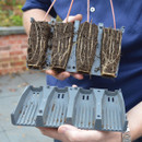 A person separating the propagator cells to display the plant's roots.