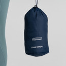 A navy blue Craghoppers compressible packaway pouch hangs against a neutral background. Text on pouch suggests compact and portable design.