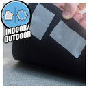 Hand applying duct tape on a black surface with an "INDOOR/OUTDOOR" label inset.