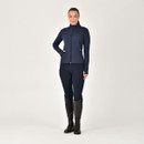 Person in navy blue equestrian outfit with black riding boots, standing against a white background.