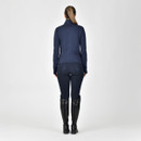 Woman from behind wearing a navy jacket and breeches with black riding boots on a white background.