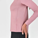 Close-up of a person in a pink base layer riding top focusing on the fabric and fit.