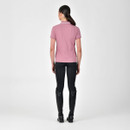 Person from behind wearing a pink polo shirt, black leggings, and tall black boots.