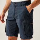 A close up view of the navy vintage look shorts with a person's hand in one of the side pockets.