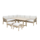 Kettler Cora Rope corner garden lounge set with light wood-effect frame, woven rope sides, cream cushions, rectangular dining table and two matching footstools, shown on a white background.