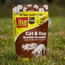 A view of cat and dog scatter granules in a yellow pouch on a green lawn