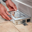 A view of someone setting up a ready baited mouse trap