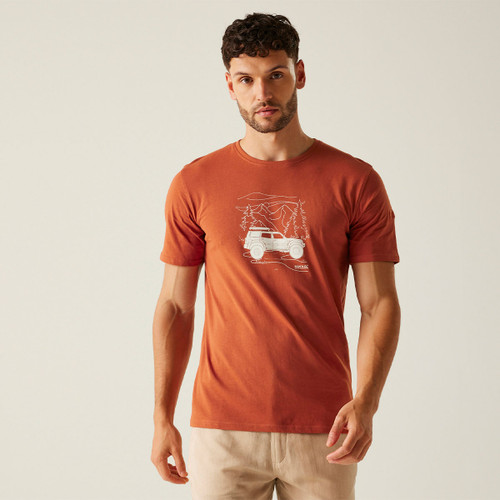 A man wearing a dark orange t-shirt with a white jeep print in the centre.