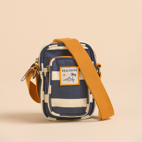 Small striped shoulder bag in navy and cream with an orange strap, featuring a "Brakeburn" logo and palm tree design.