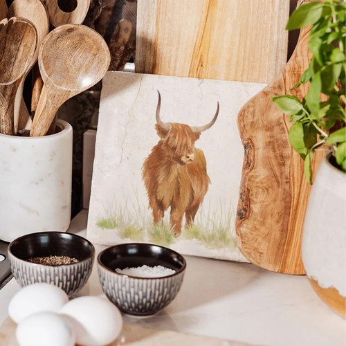 A view of a medium marble platter with a highland cow on it