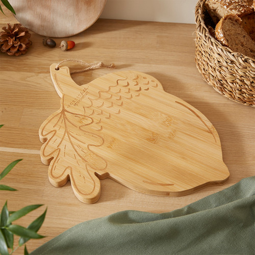 A view of an acorn shaped bamboo Cooksmart Forest fable serving board on a wooden table
