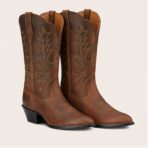 Pair of brown leather Western cowboy boots with decorative contrast stitching, pointed toes and stacked heels.