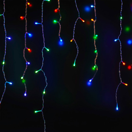 Multicoloured icicle lights hanging in front of a black background.