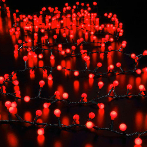 Red LED berry string lights with glowing spherical bulbs on a dark cable, creating a warm festive lighting display for Christmas trees, garlands and seasonal decorations.