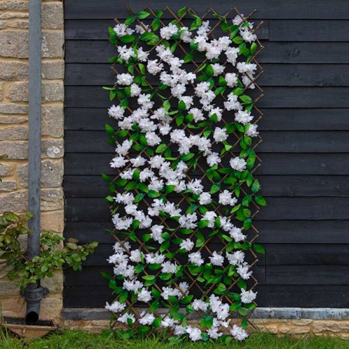 A faux cherry blossom trellis with green leaves.