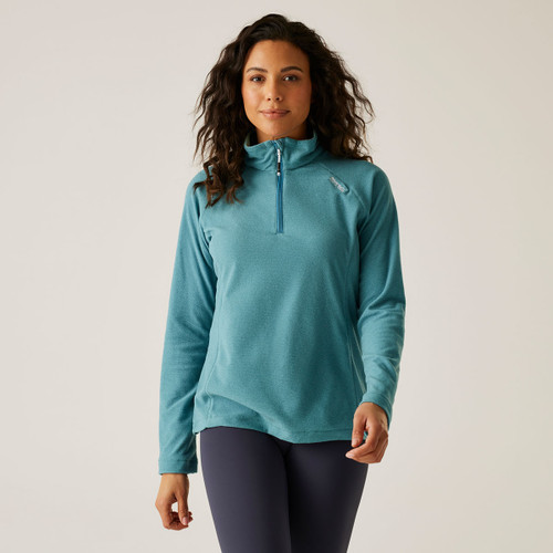 A woman wearing a light blue coloured half zip fleece.