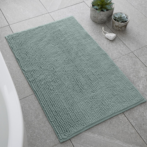 A view of a sage Catherine Lansfield bobble bath mat on a tiled floor