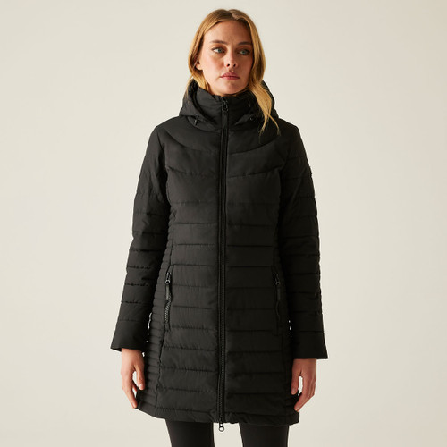 A woman wearing a long, black quilted jacket with a hood.