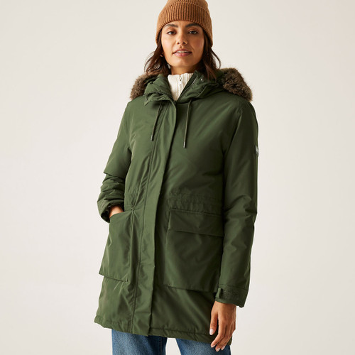 A woman wearing a khaki green jacket with a faux fur hood trim.