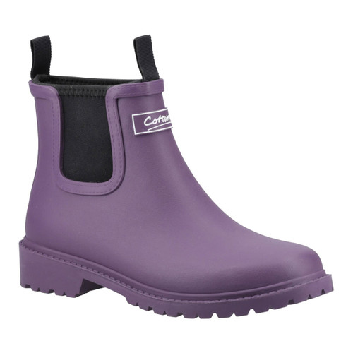 Cotswold Women's purple ankle-length wellington boot with pull tabs and black elastic side panels, featuring a chunky tread sole.