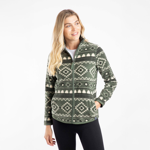 Woman wearing a zip-up fleece jacket in deep lichen green with an off-white geometric pattern. The jacket has a high collar, side pockets, and a relaxed fit.