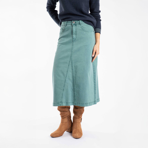 The front of a person wearing a deep teal coloured denim midi skirt with brown boots.