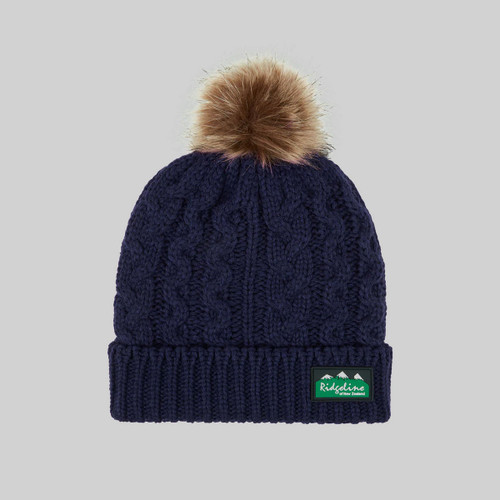 A view of a navy Ridgeline bobble hat on a grey background