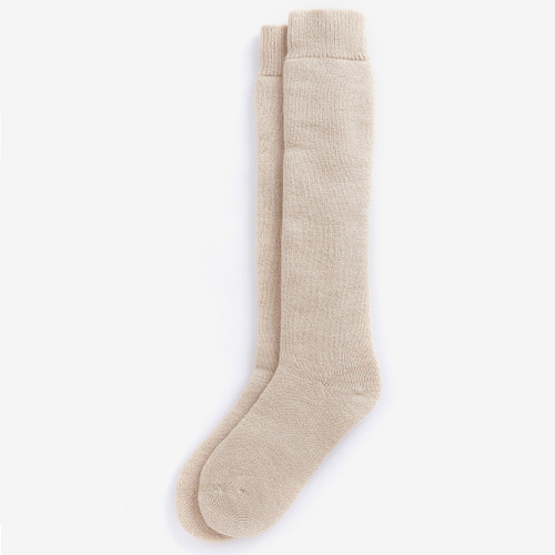 Beige knee-high socks lie on a white surface, neatly aligned. The texture appears soft, giving a cosy and warm impression.