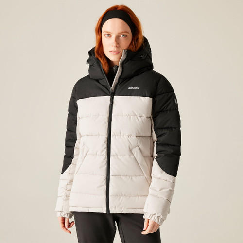 A woman wearing a contrasting white and black padded jacket with a hood.