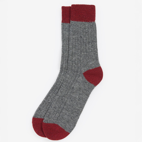 Gray ribbed socks with maroon cuffs, heels, and toes, displayed against a white background. They convey a cosy, classic aesthetic.